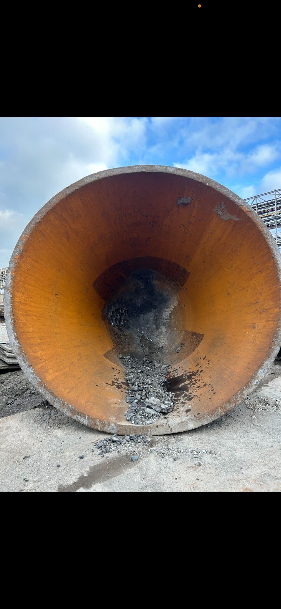 Slag pot at outdoor site with slag debris before cleaning